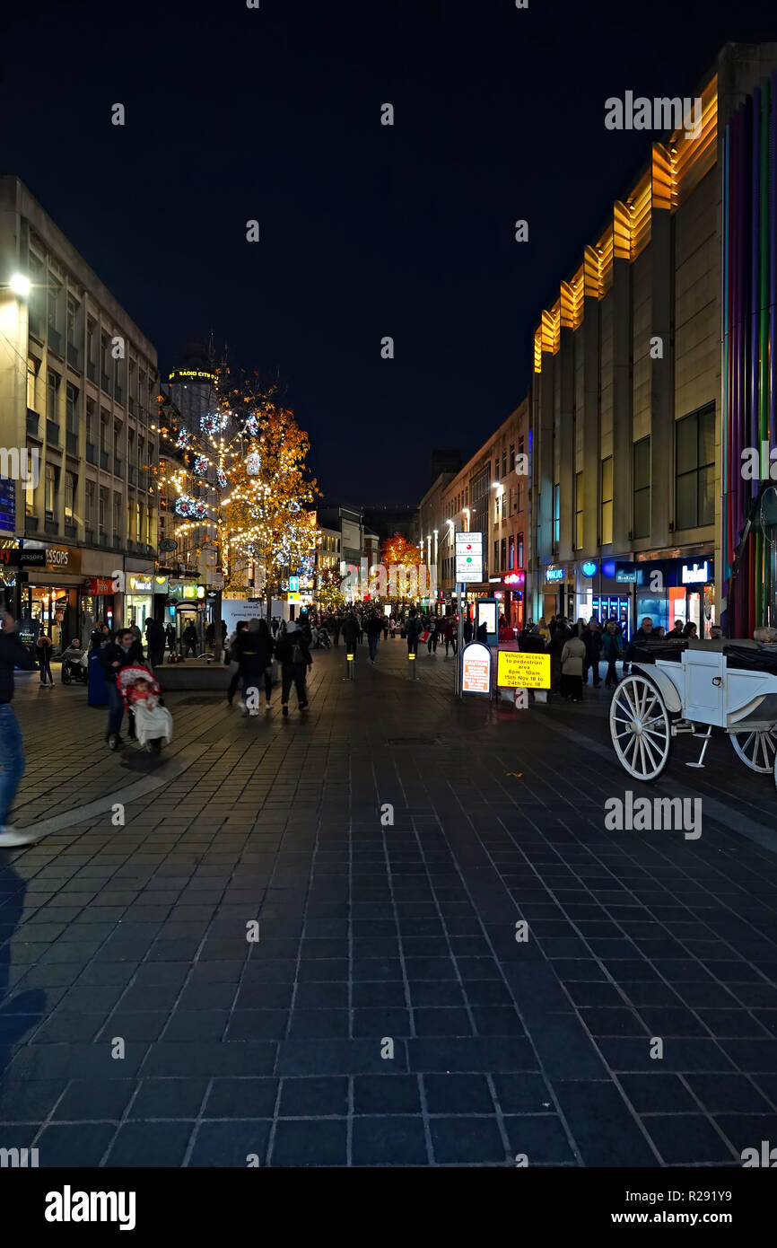 People out shopping at nighttime on Church St Liverpool UK with Christmas lights on the trees. November 2018. Stock Photo