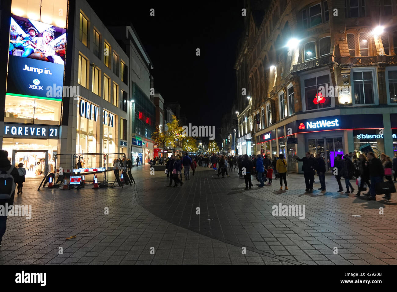 People out shopping at nighttime on Church St Liverpool UK with Christmas lights on the trees. November 2018. Stock Photo