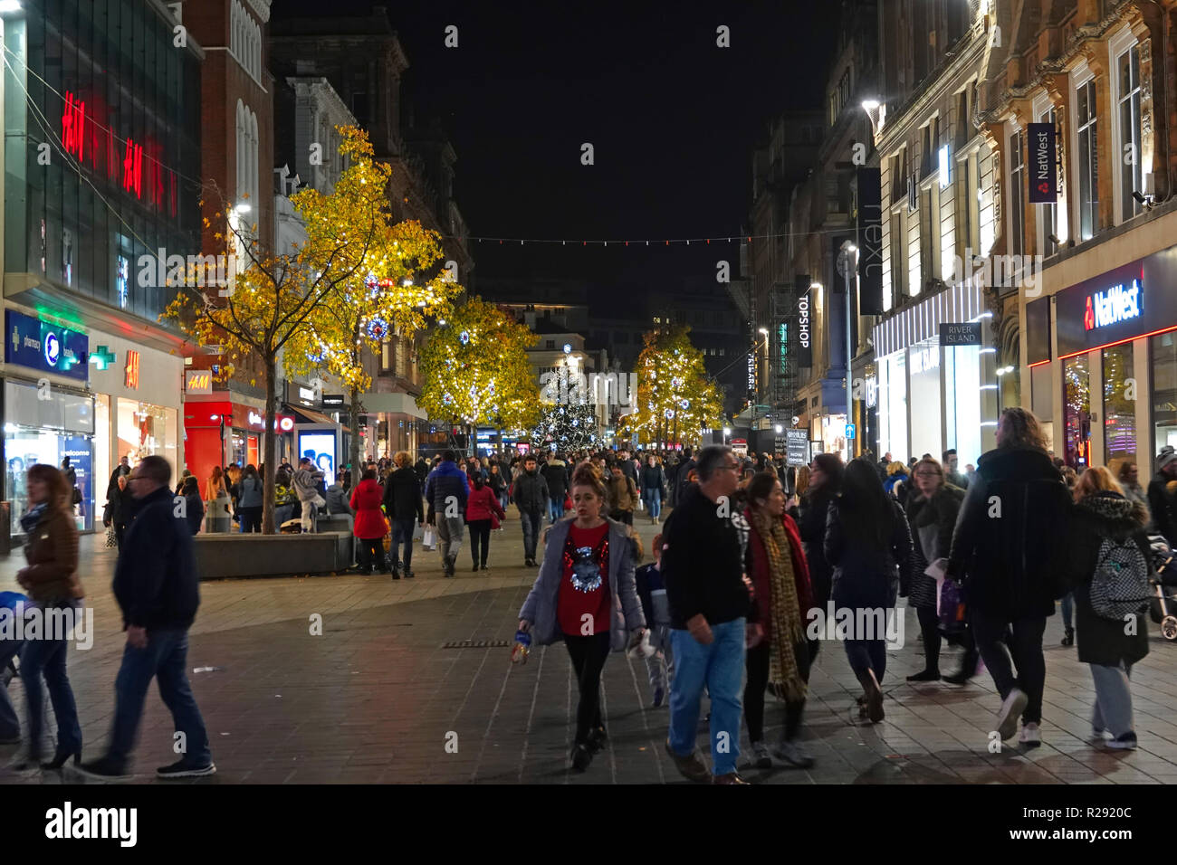 People out shopping at nighttime on Church St Liverpool UK with Christmas lights on the trees. November 2018. Stock Photo