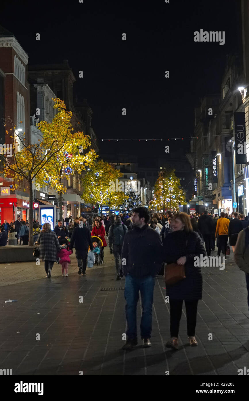 People out shopping at nighttime on Church St Liverpool UK with Christmas lights on the trees. November 2018. Stock Photo
