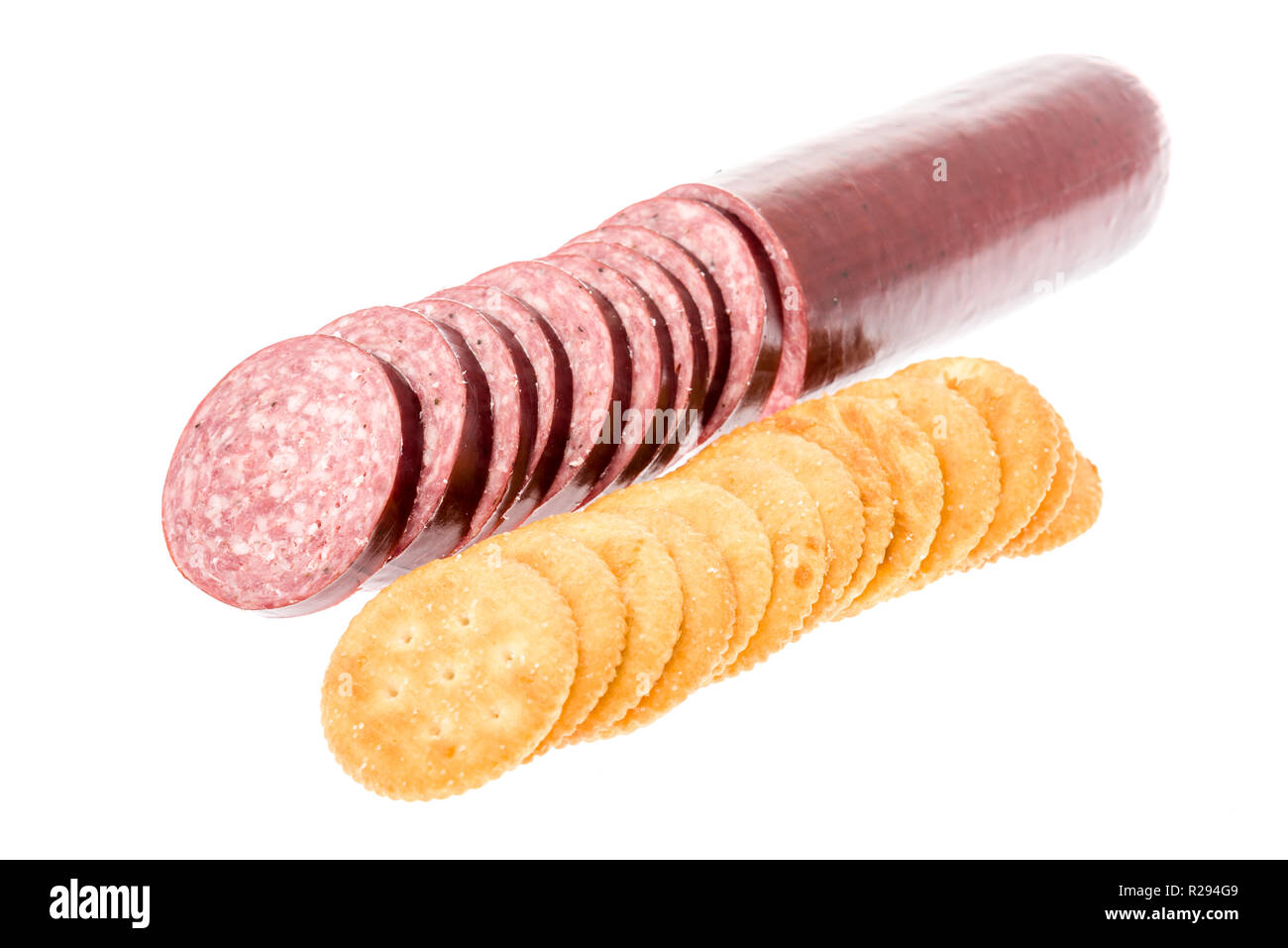 Summer sausage sliced with crackers on an isolated background Stock