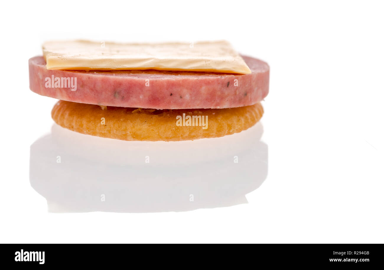 A cracker with summer sausage and cheese to make finger food