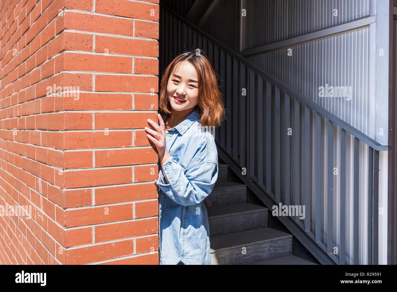 Smiling and confindent girl student looking at camera on campus Stock Photo