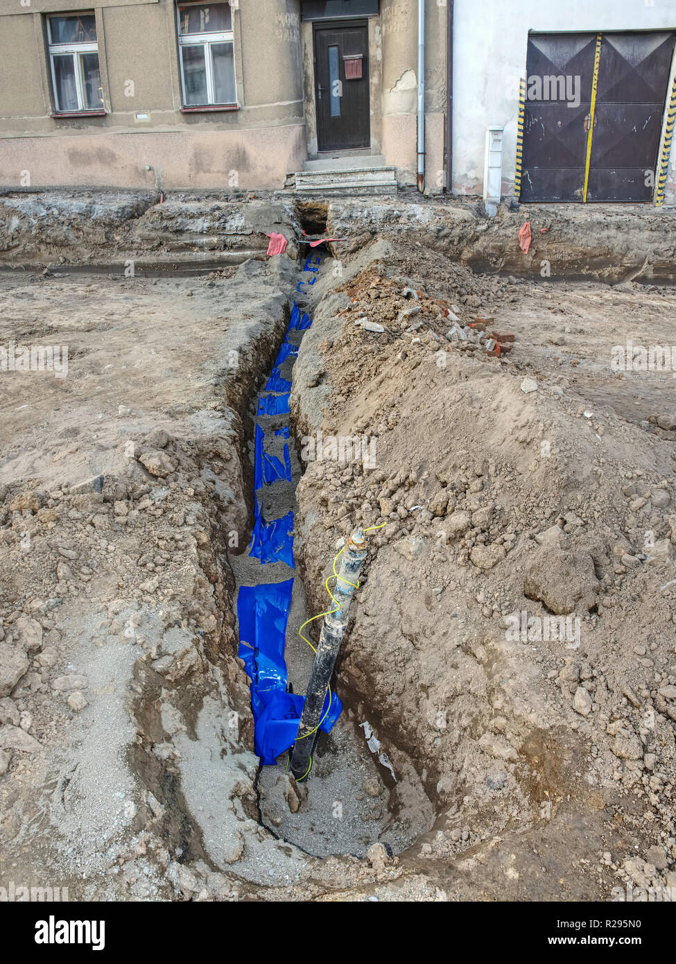 Installing new water pipes in old town street, maintenance work, dig