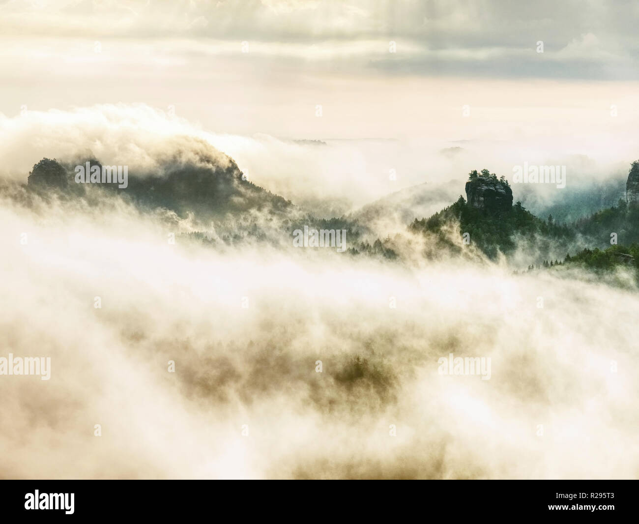 Strong Sun Rays Hiil peaks increased from heavy fog. The first strong sun rays cut the ...