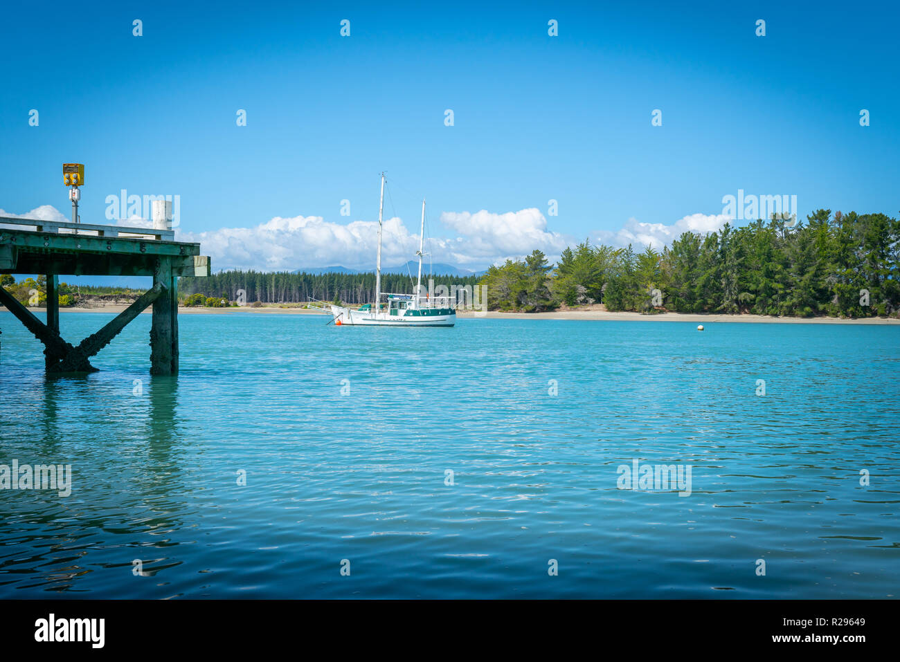 Wharf at Mapua with slopp moored in channel of Waimea Estuary on Tasman