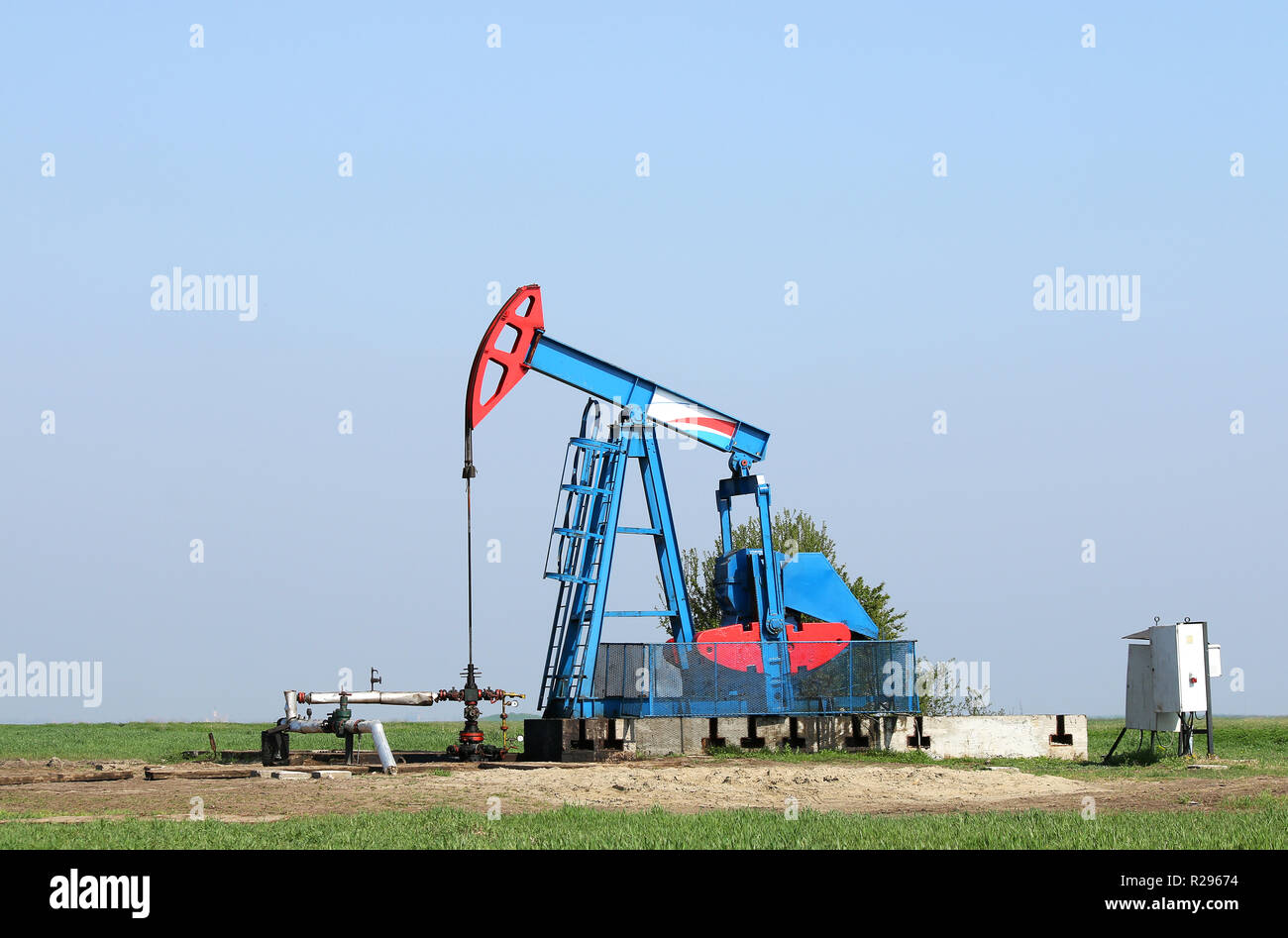 oil pump jack and pipeline on field Stock Photo