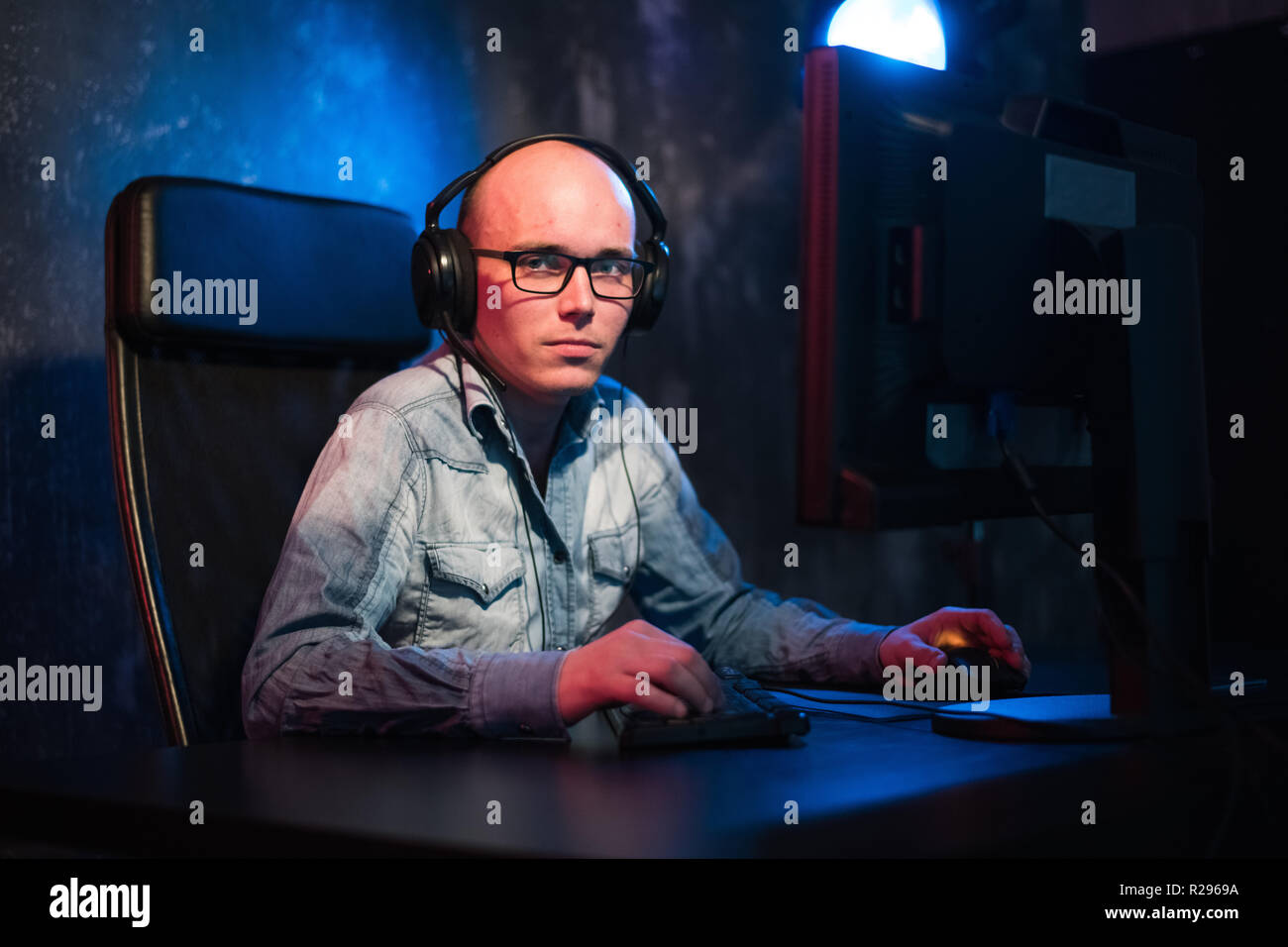 Happy young man with headset working at home. Stock Photo