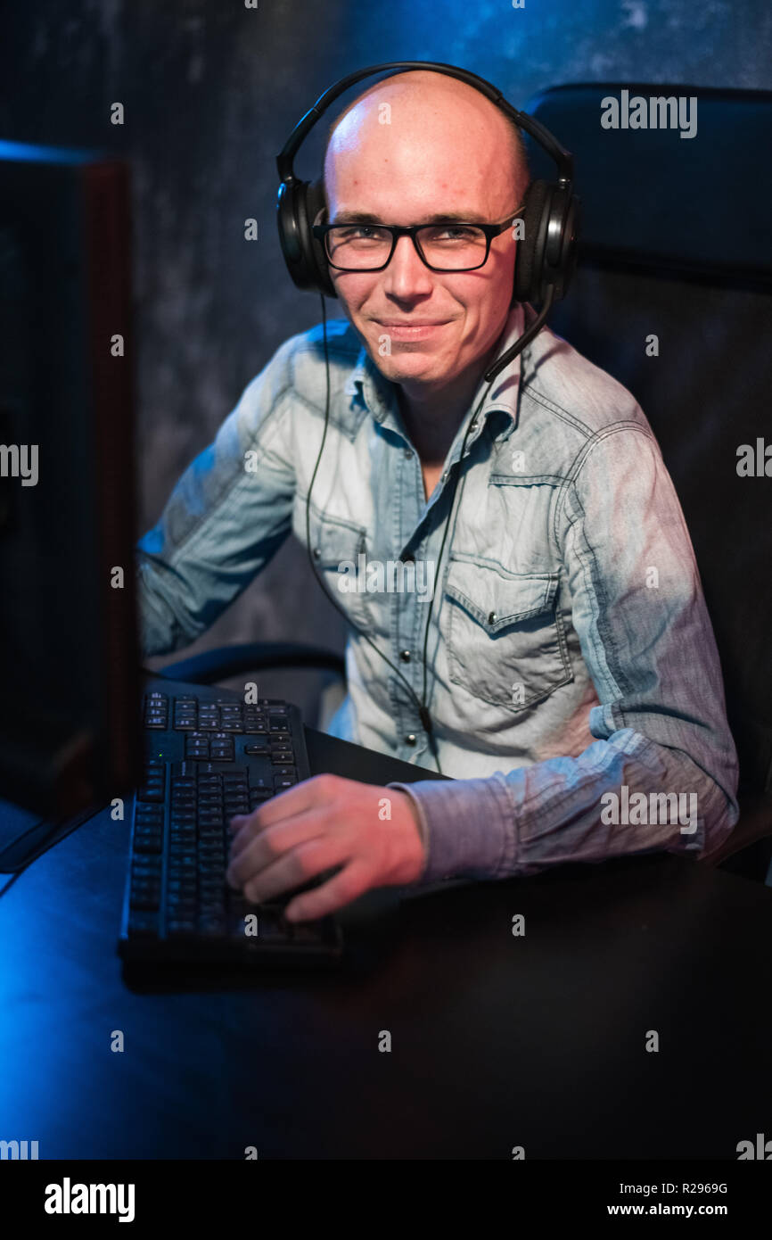 Happy young man with headset working at home. Stock Photo