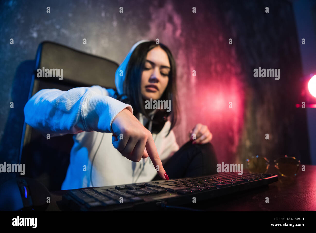 Woman hacker is ready to run malware program virus on the internet. Start hacking remote system computer. Stock Photo