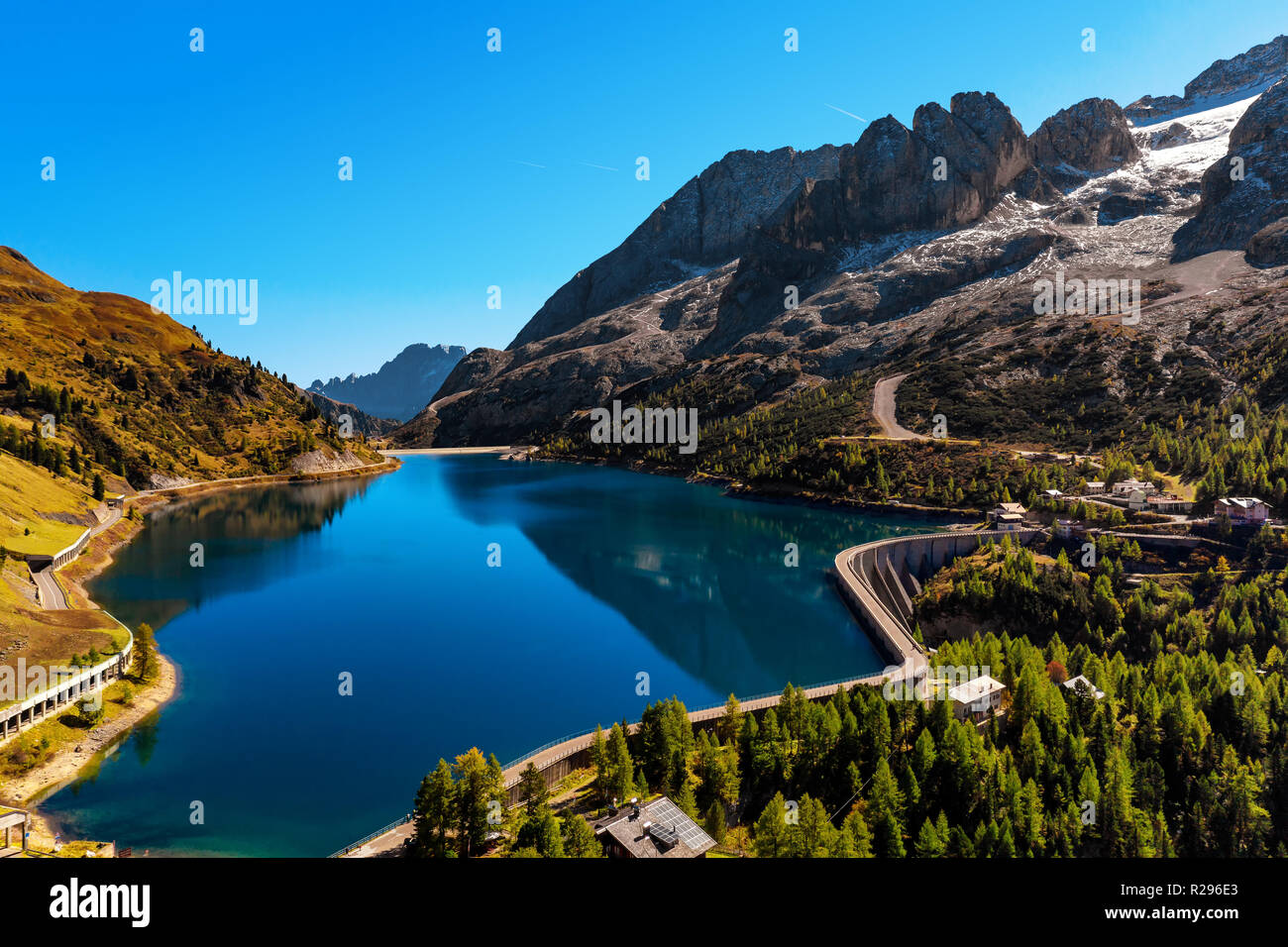 dam-and-mountain-lake-at-the-fedaia-pass-hi-res-stock-photography-and