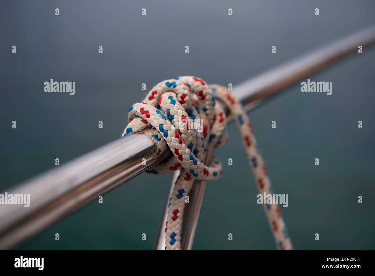 Small rope knot tied around silver metal rod. Close up of a knot Stock  Photo - Alamy