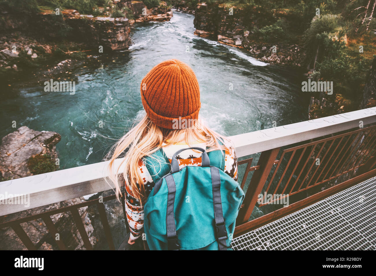 Woman solo traveling with backpack vacations outdoor active adventure healthy lifestyle enjoying river canyon in Sweden Stock Photo