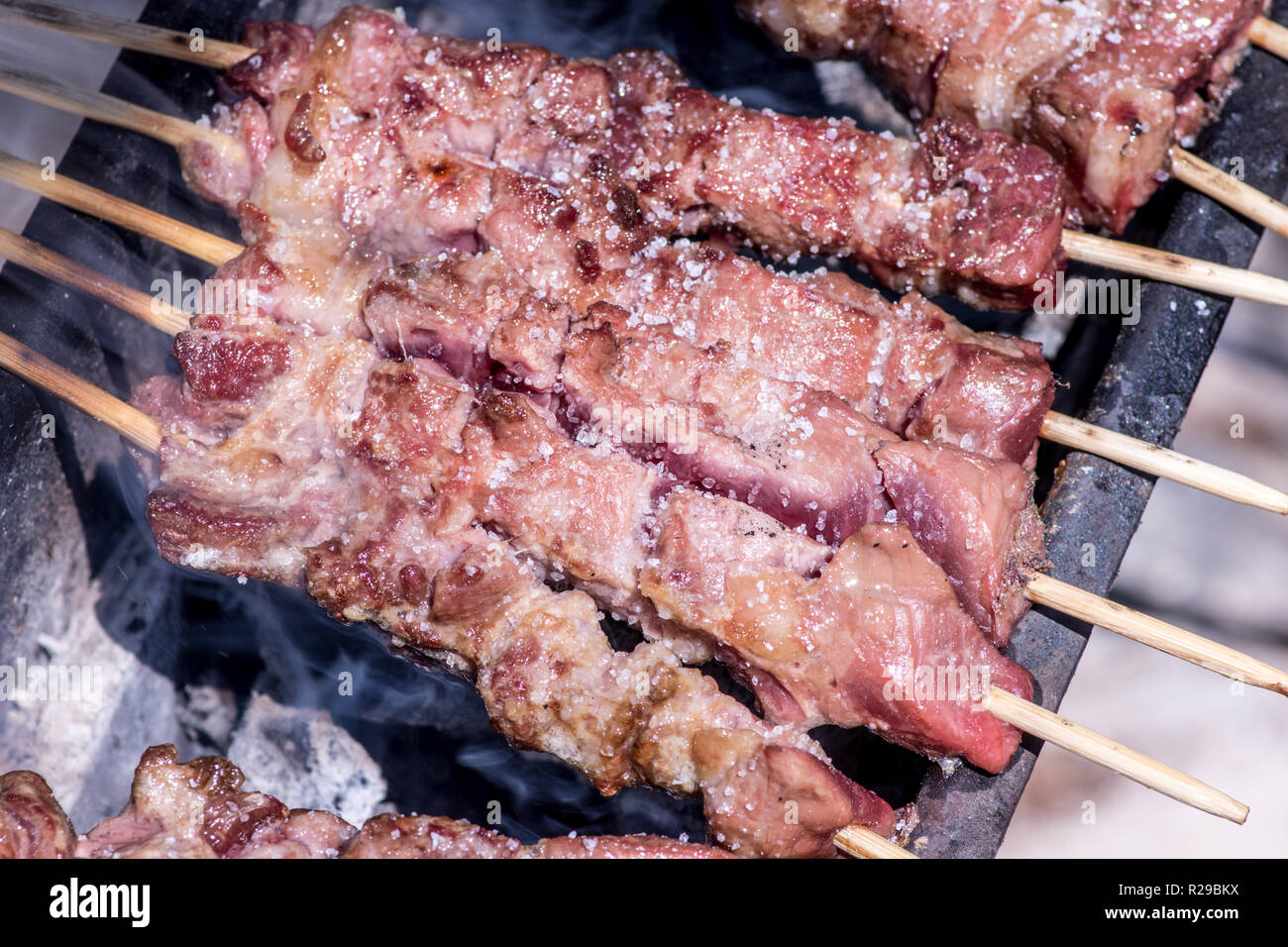 Arrosticini (rustelle or arrustelle in the local dialects; also known as spiedini or spidducci) are typically made from castrated sheep's meat (mutton Stock Photo