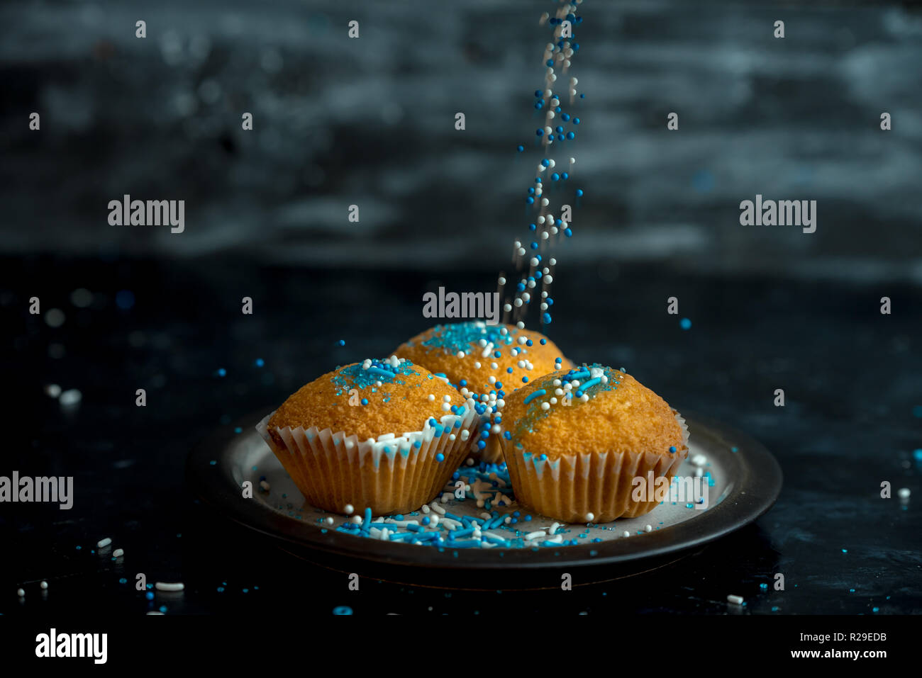 lemon muffins sprinkled with blue and white sprinkles Stock Photo Alamy