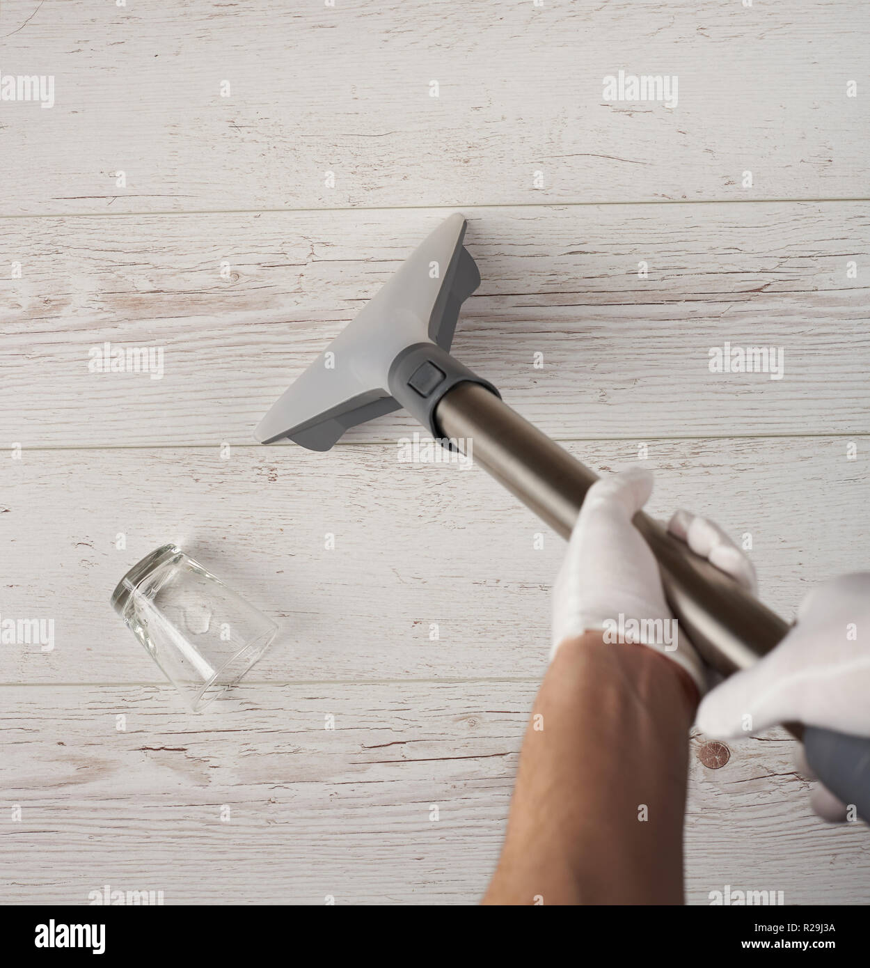 Cleaning white wooden floor from water spill above top view Stock Photo