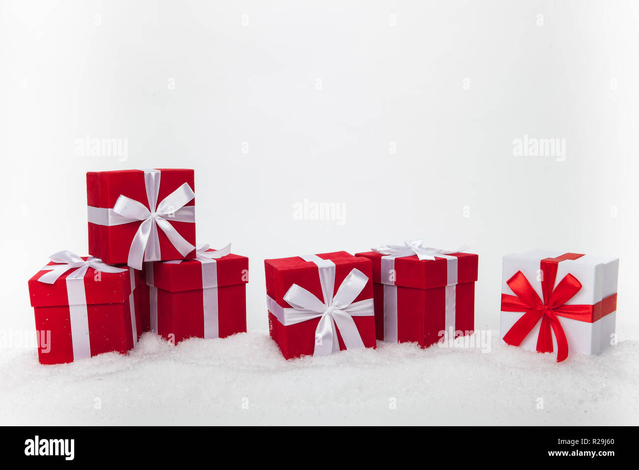 Christmas red and white gift boxes stay on a snow. Isolated Stock Photo ...