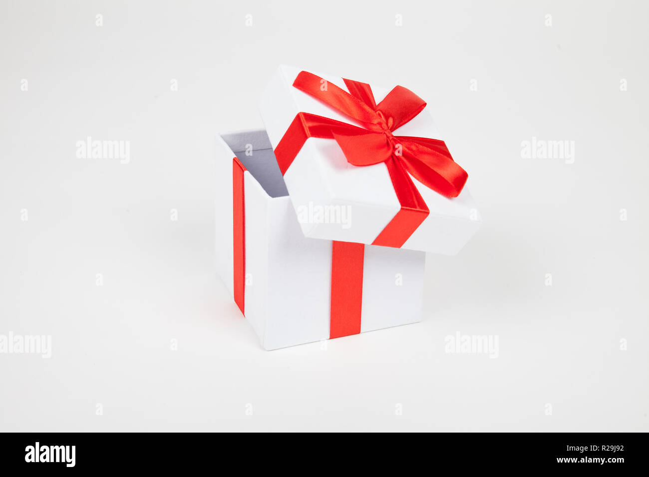White gift box with red bow isolated on white background Stock Photo ...