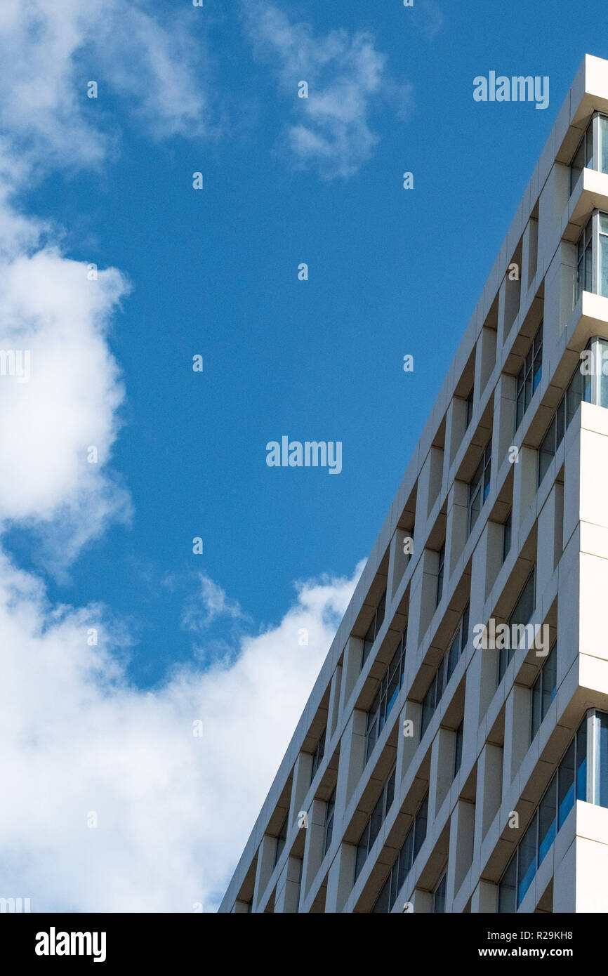The facade of a multistory building against the blue sky Stock Photo ...