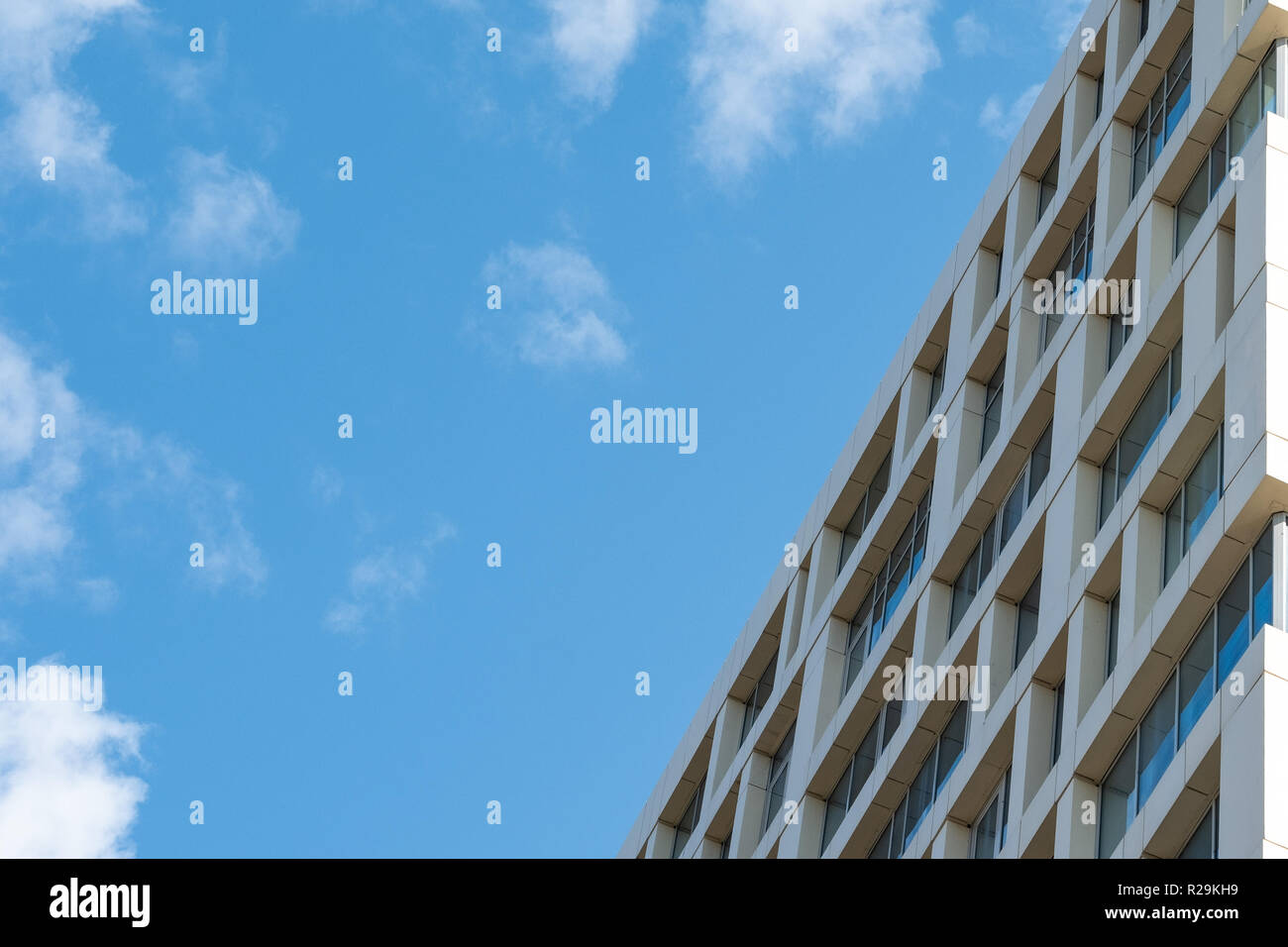 The facade of a multistory building against the blue sky Stock Photo ...