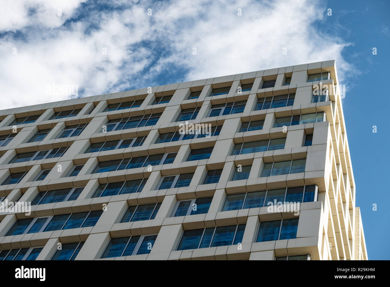 The facade of a multistory building against the blue sky Stock Photo ...