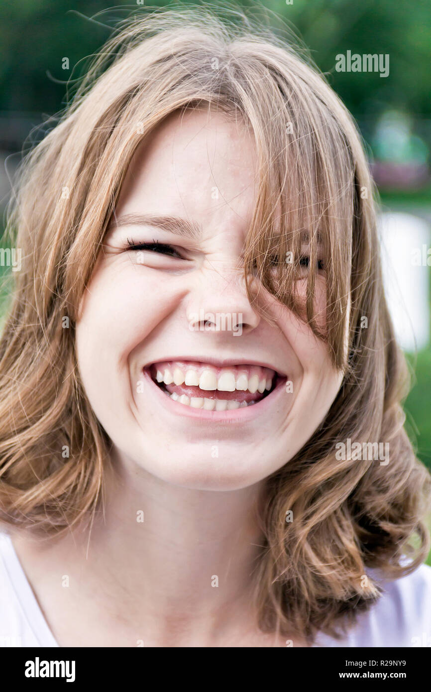 Portrait of laugh blond girl fourteen years old Stock Photo