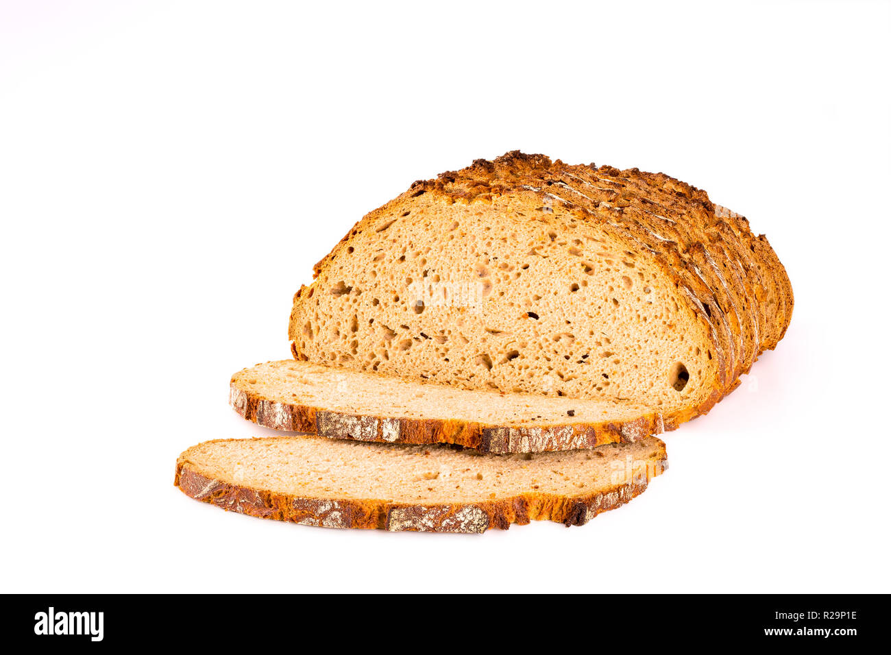 Loaf and slices of bread isolated on white background, front view, closeup. Stock Photo