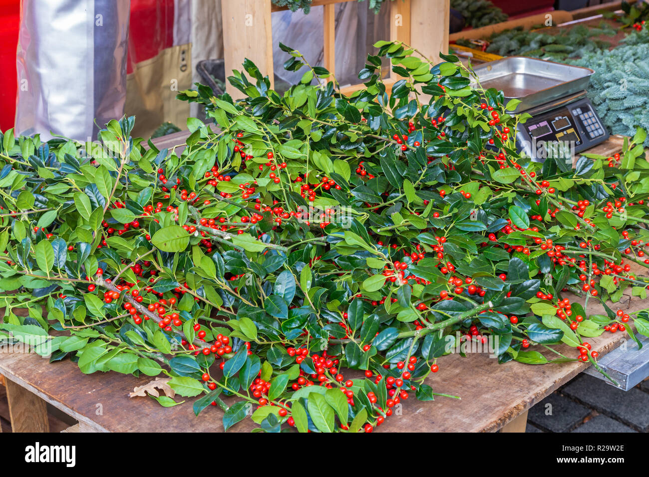 Holly branches and decoration for sale on a market Stock Photo Alamy