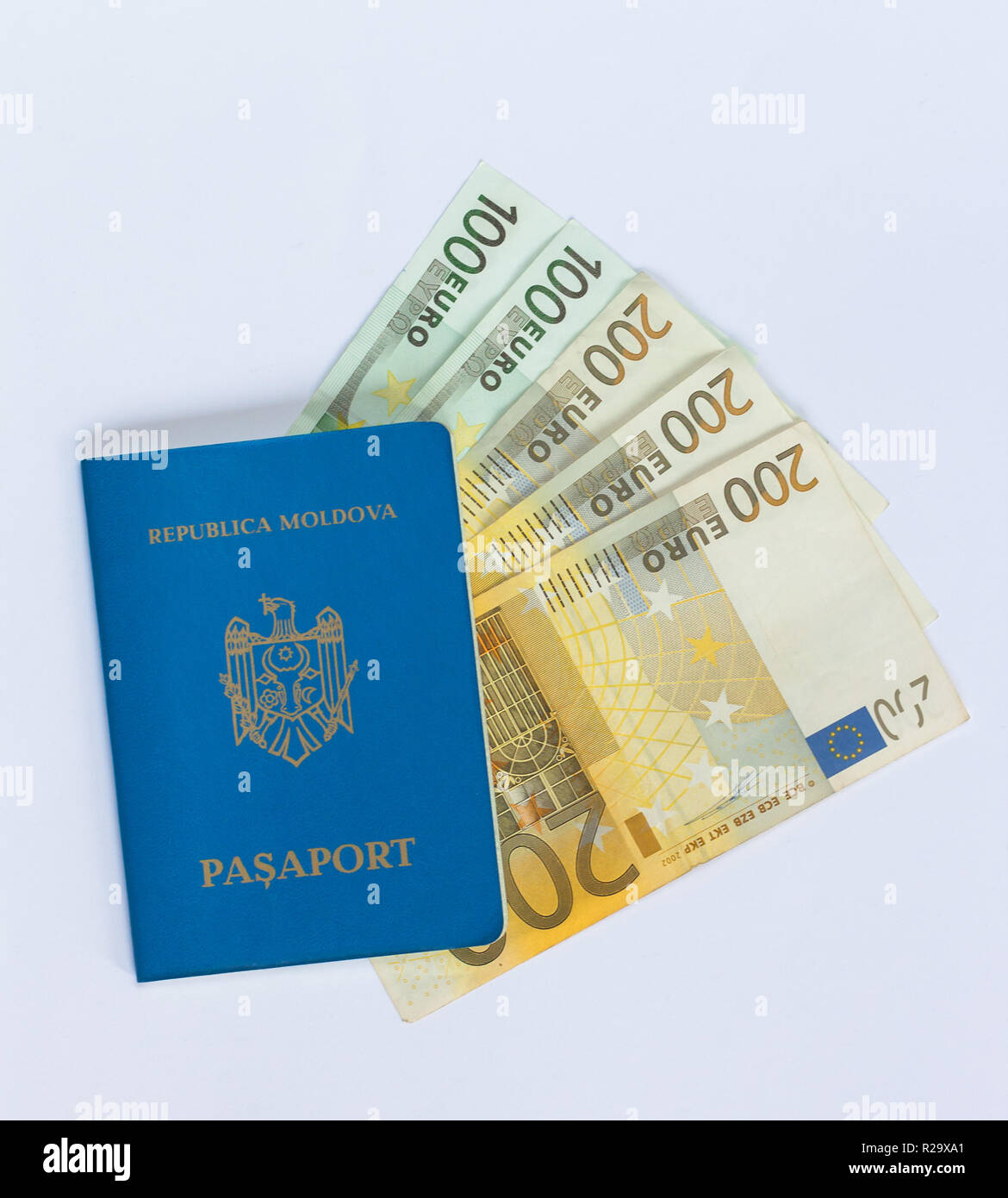 Blue Moldavian travel passport laying on different euro banknotes. Stock Photo