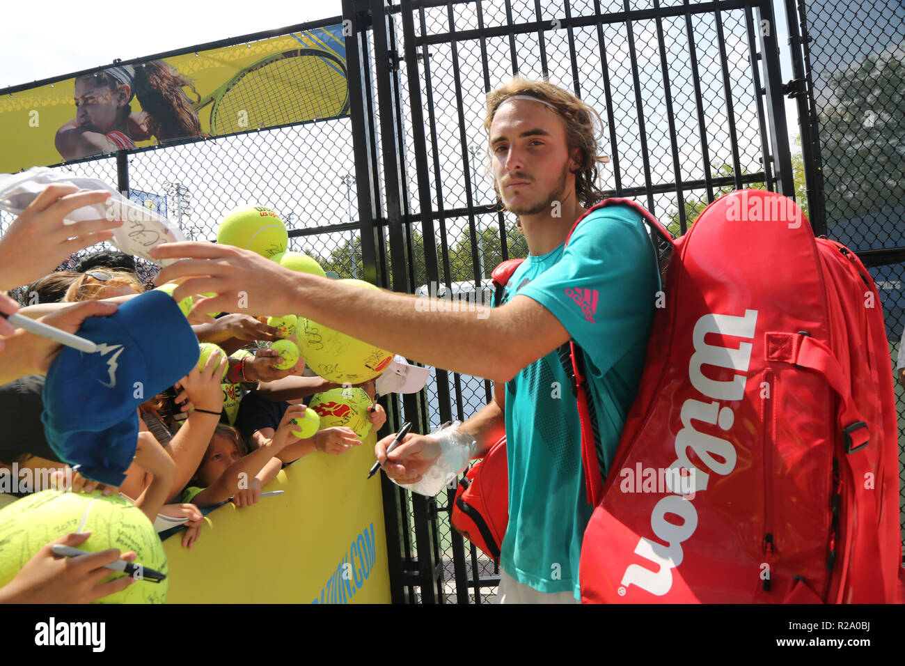 Professional tennis player Stefanos Tsitsipas of Greece signs autographs after practice for 2018 US Open at Billie Jean King National Tennis Center Stock Photo