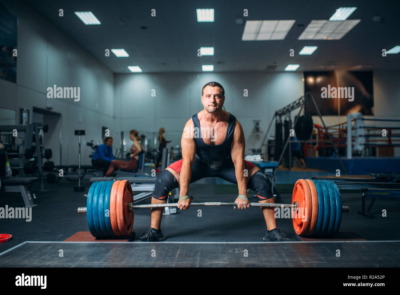 Male weightlifter prepares to pull heavy barbell deadlift gym interior on background. Weightlifting workout in sport or fitness club bodybuilding Stock Photo Alamy