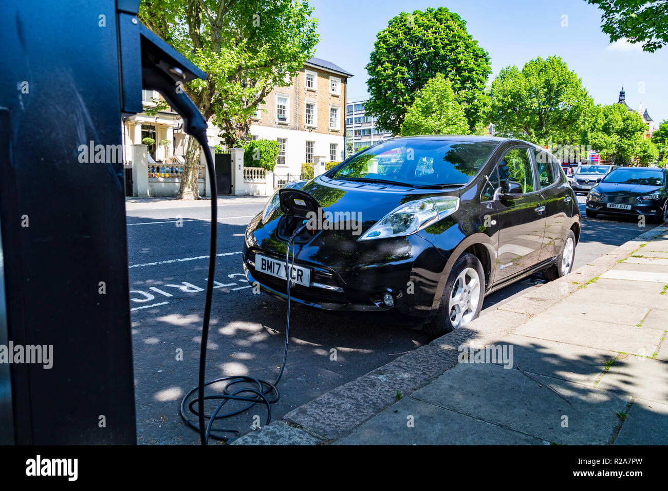 Electric cars charging in London, UK Stock Photo