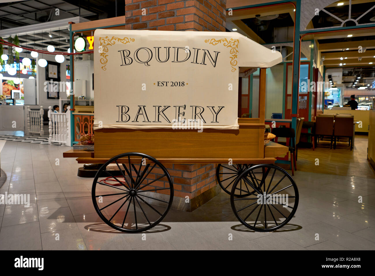 Replica vintage bakery and bread cart used as an advertising prop for artisan bakery shop. Stock Photo