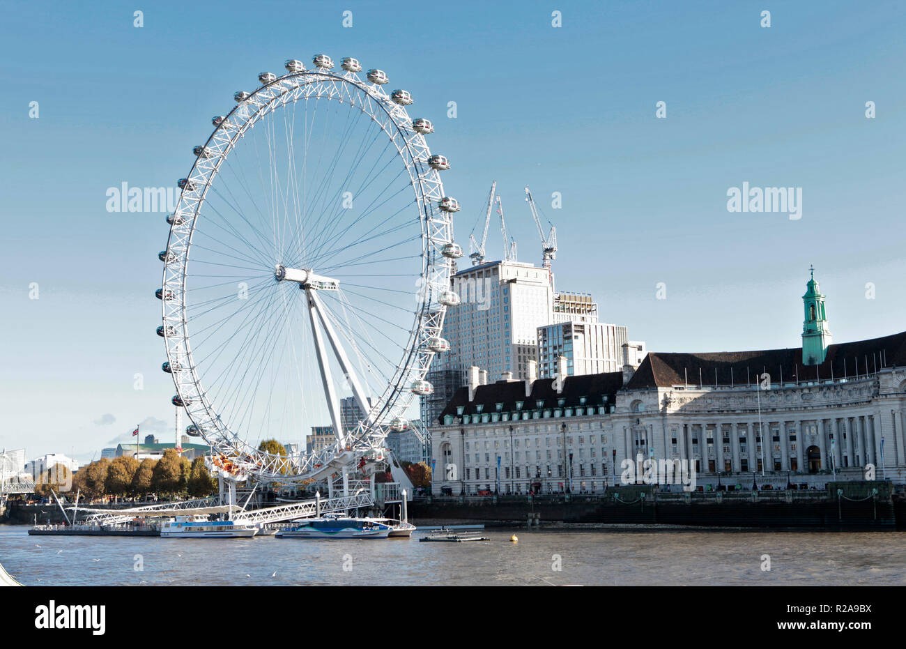the london eye, and city hall seen from the westminster side of the thames river, london, uk Stock Photo