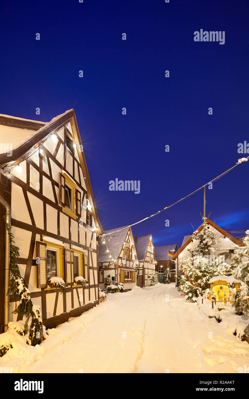 An old village street with half-timbered houses and christmas decoration at night during snowfall in Lachen, Neustadt an der Weinstrasse, Germany. Stock Photo