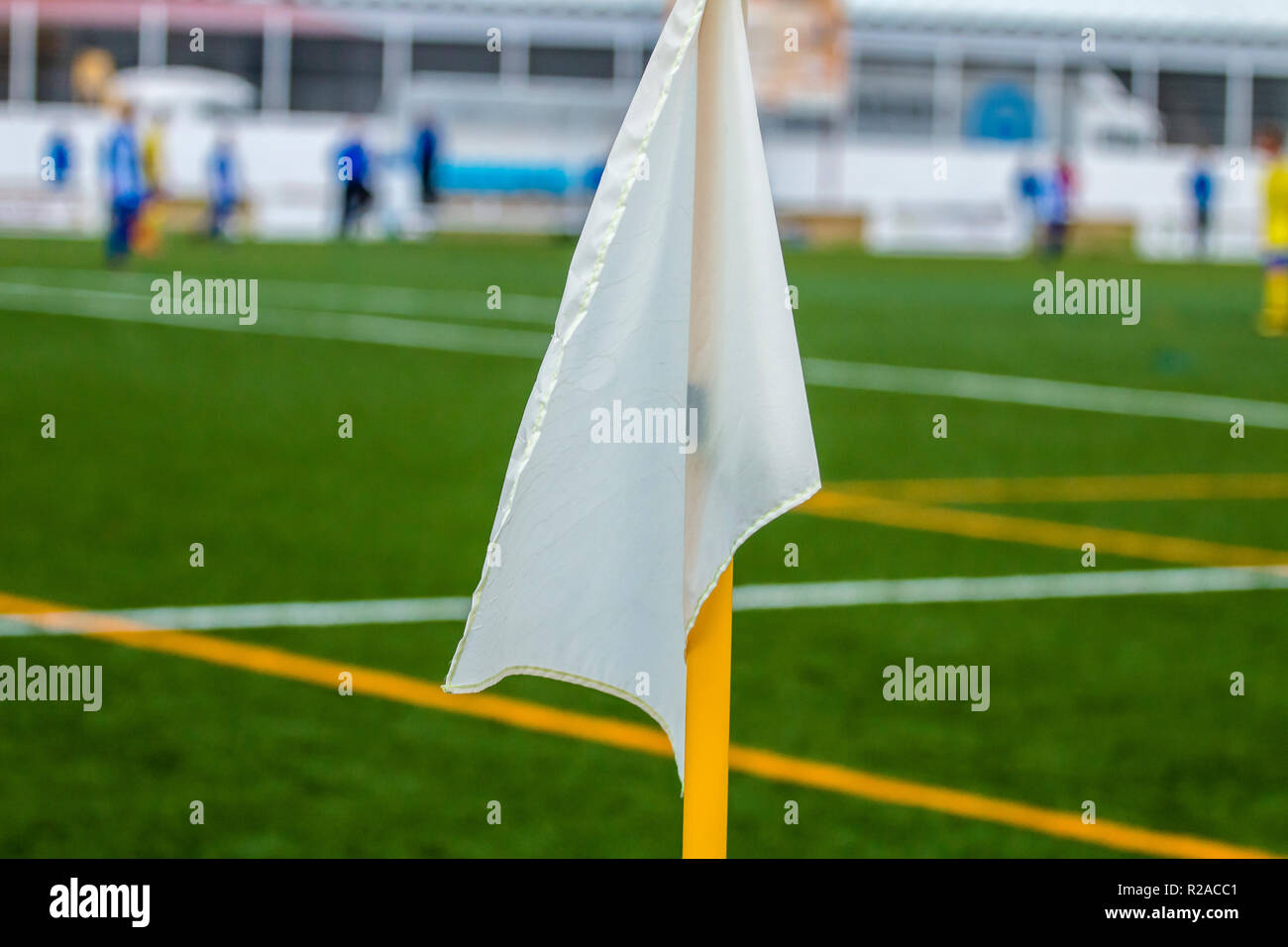 White corner flag closeup on the background of a football field