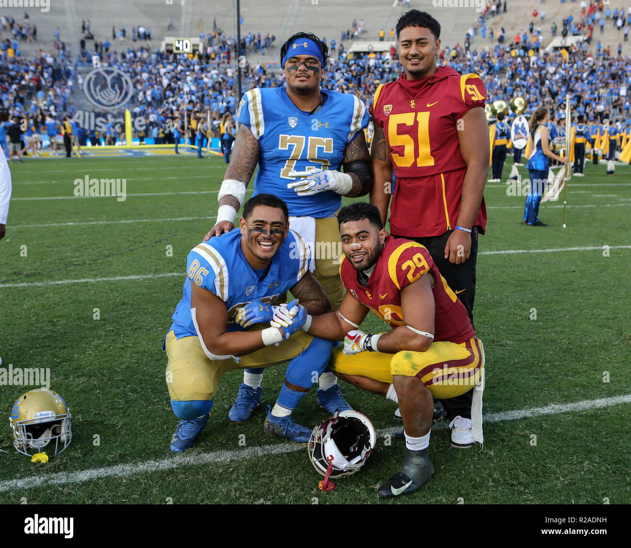 Pasadena CA. 17th Nov, 2018. UCLA Bruins tight end Devin Asiasi #86, offensive lineman Boss Tagaloa #75 and USC Trojans running back Vavae Malepeai #29, defensive lineman Marlon Tuipulotu #50 after the USC Trojans vs UCLA Bruins at the Rose Bowl in Pasadena, Ca. on November 17, 2018 (Photo by Jevone Moore) Credit: csm/Alamy Live News Stock Photo