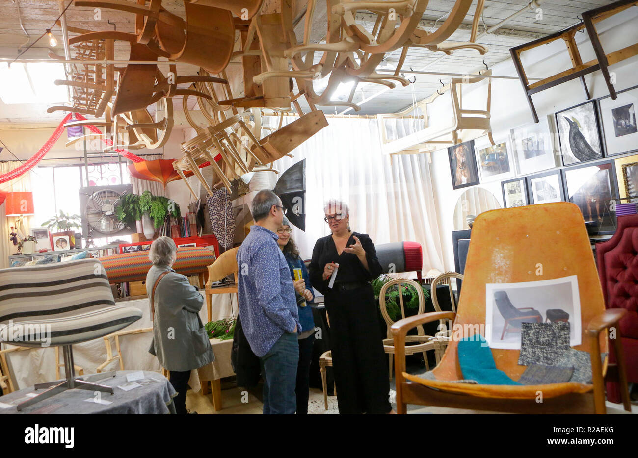 Vancouver, Canada. 17th Nov, 2018. People look at the works of an artist in  a studio during the annual Eastside Culture Crawl in Vancouver, Canada,  Nov. 17, 2018. Eastside Culture Crawl is