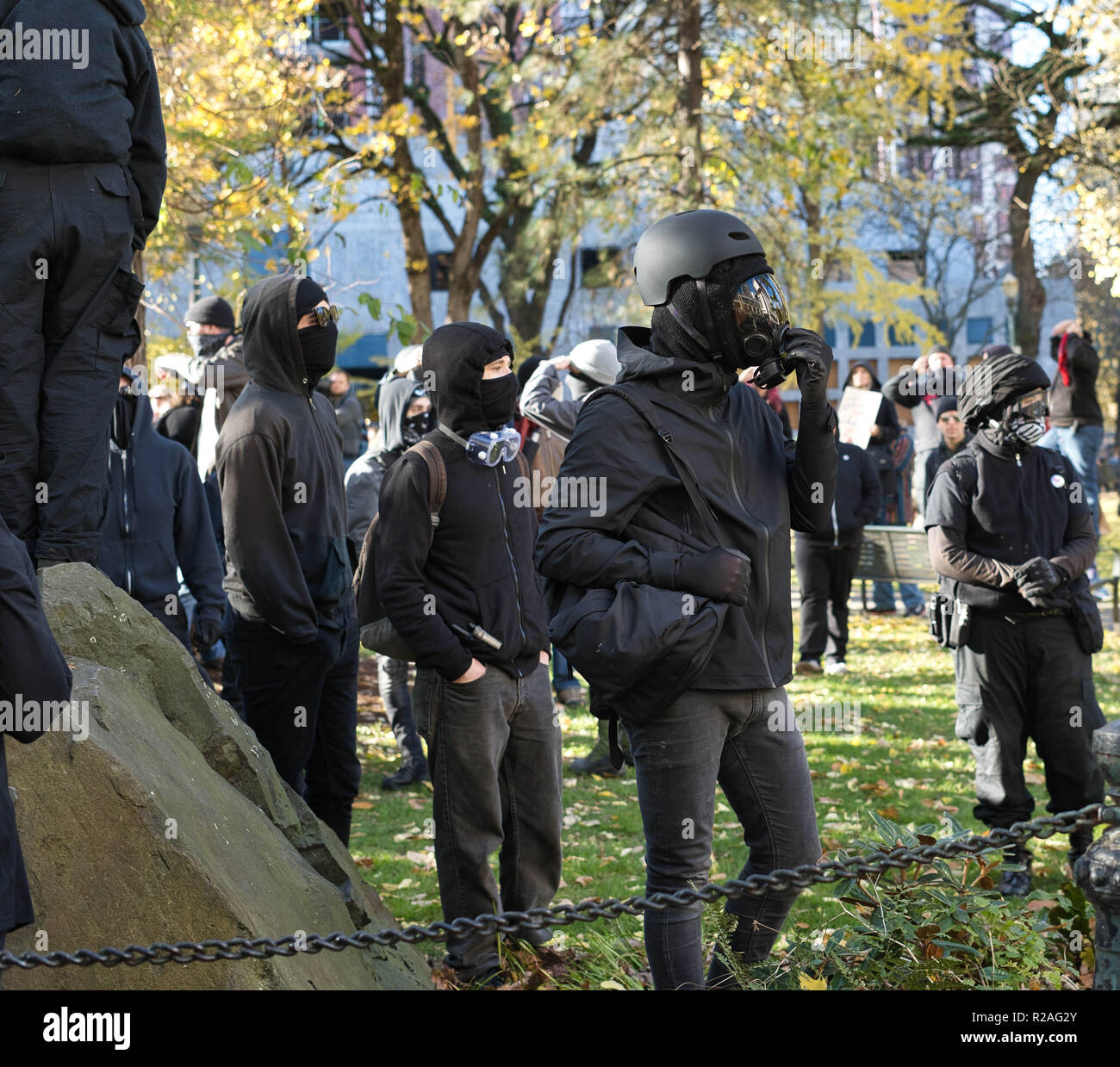 Dressed in all black and helmuts, these Rose City Antifa members stand ready. Stock Photo