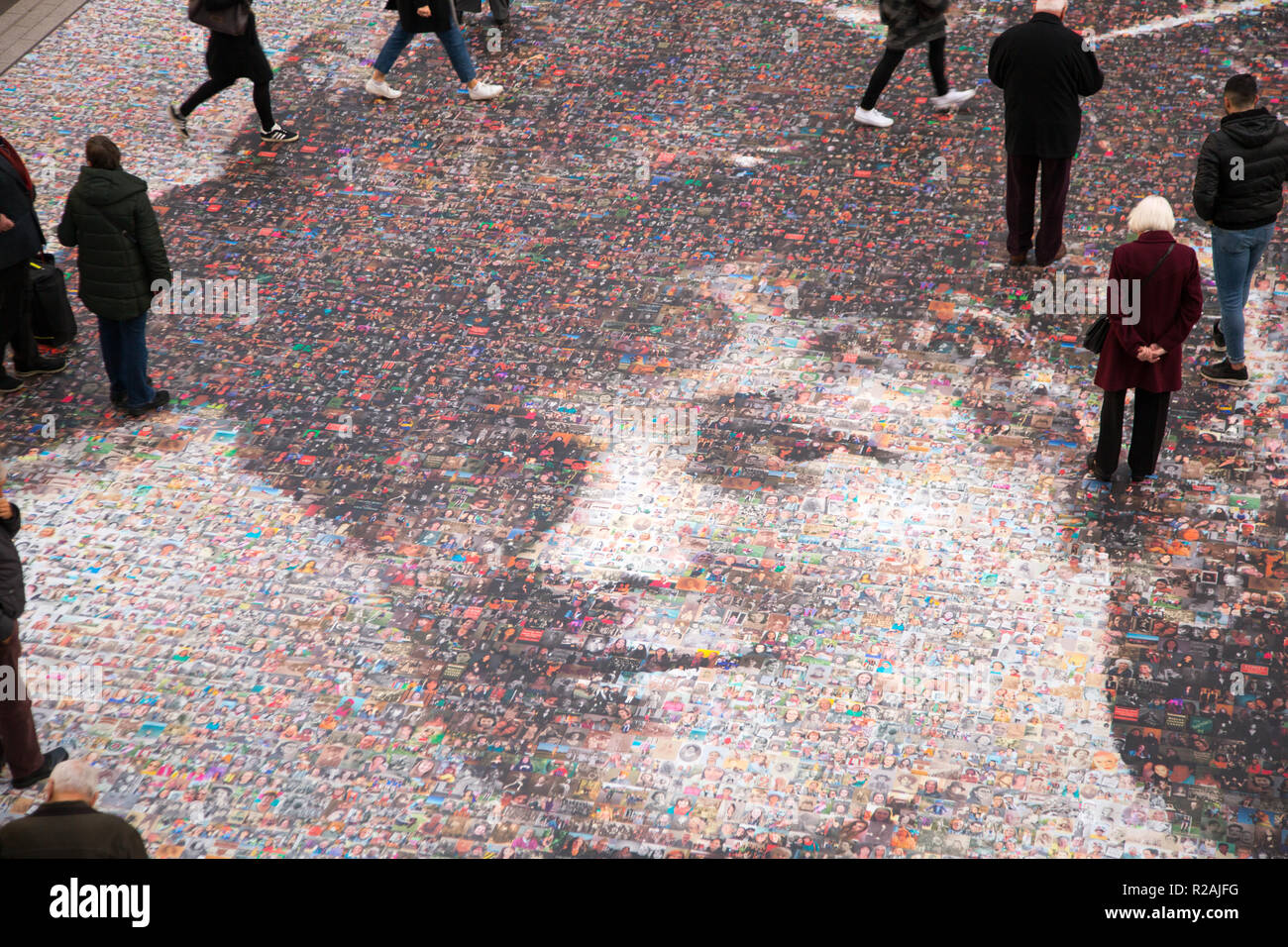 Birmingham, UK. 18th November 2018. A giant mosaic portrait of suffragette Hilda Burkitt  at Birmingham New Street station. The 20m (65ft) image is made up 3,724 selfies and other photos of women sent in from across the UK. The project, titled Face of Suffrage, is the brainchild of artist Helen Marshall and marks 100 years since the first British women voted. Credit: steven roe/Alamy Live News Stock Photo