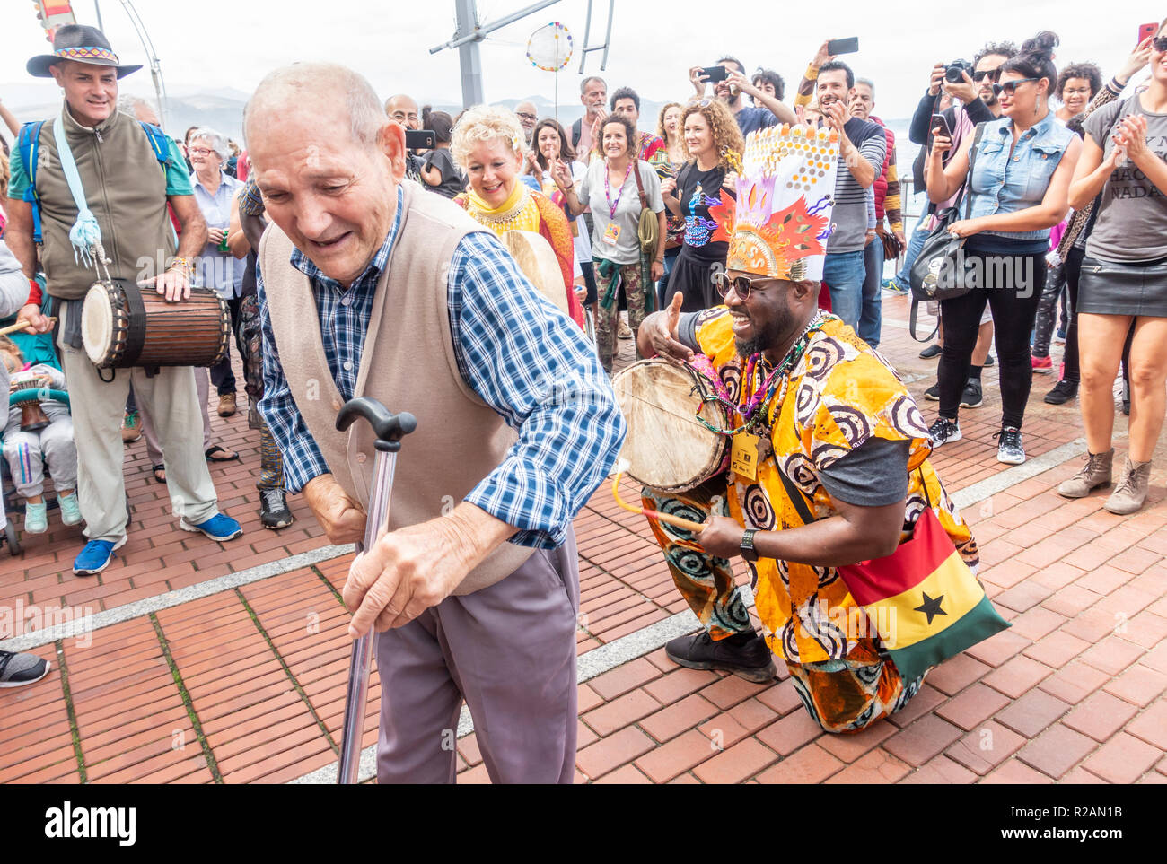 Las Palmas, Gran Canaria, Canary Islands, Spain. 18th November 2018. An  elderly local man gets out of his mobilty scooter and throws down some  moves at the WOMAD music festival closing procession