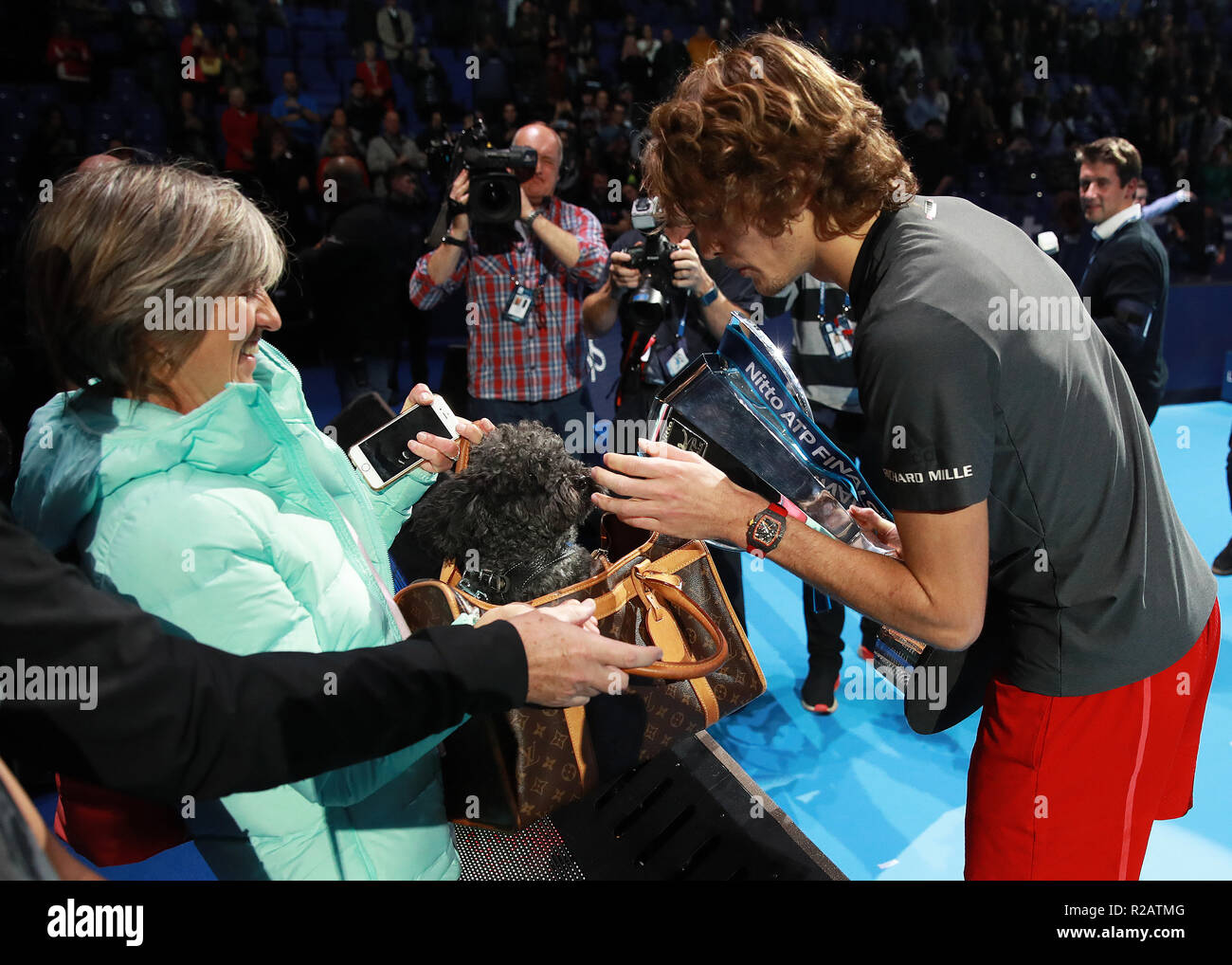 18th November 2018, O2 Arena, London, England; Nitto ATP Tennis Finals; Alexander Zverev (GER) being licked by his dog Loewik with mother Irina Zvereva as he holds the Nitto ATP Final Singles Trophy after defeating World Number one Novak Djokovic (SRB) in the Final Stock Photo