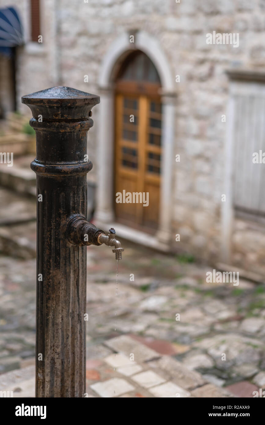 Old drinking water tap in the old town of Kotor, Montenegro Stock Photo