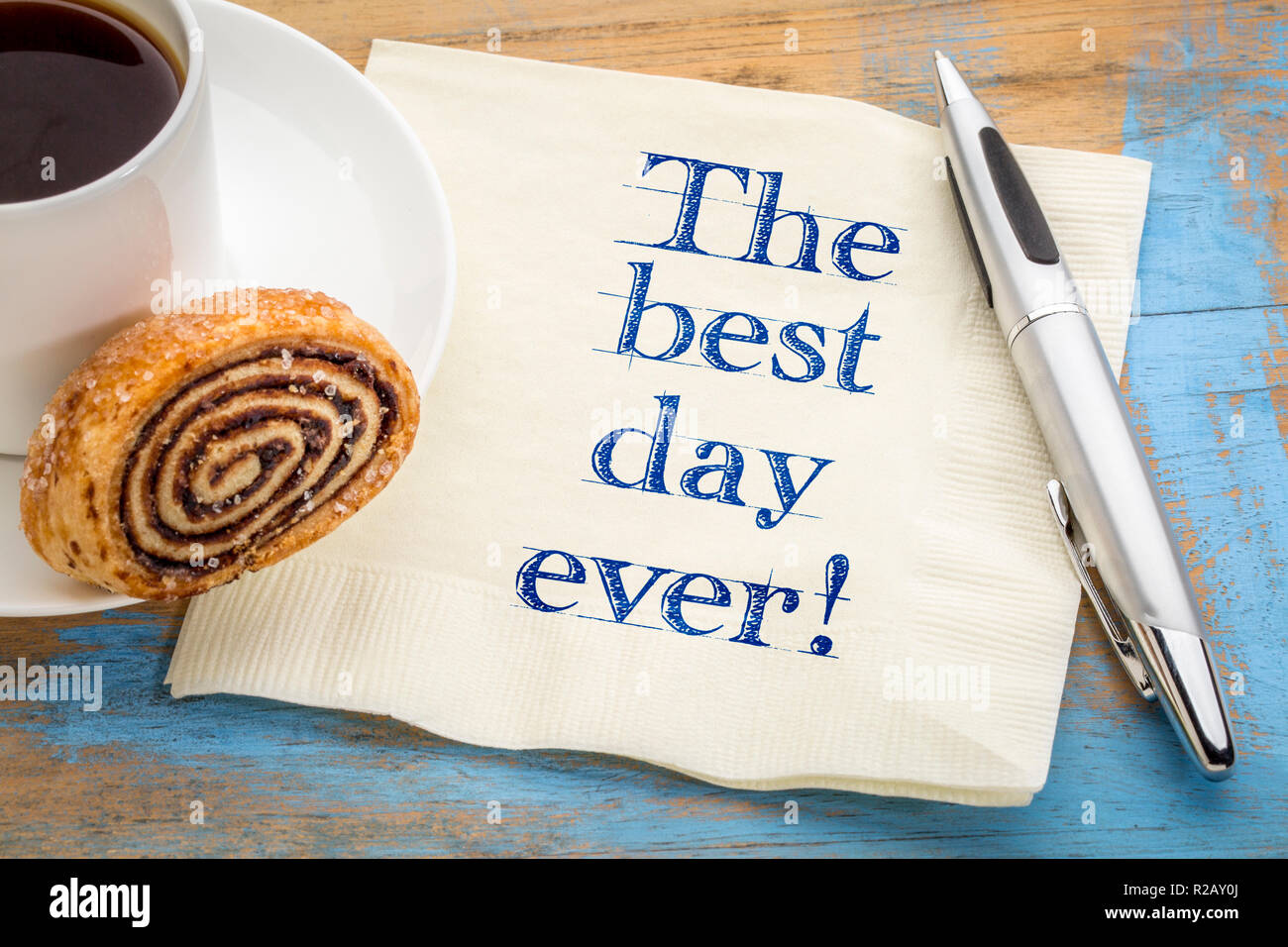 The best day ever! Positive handwriting on a napkin with a cup of coffee Stock Photo