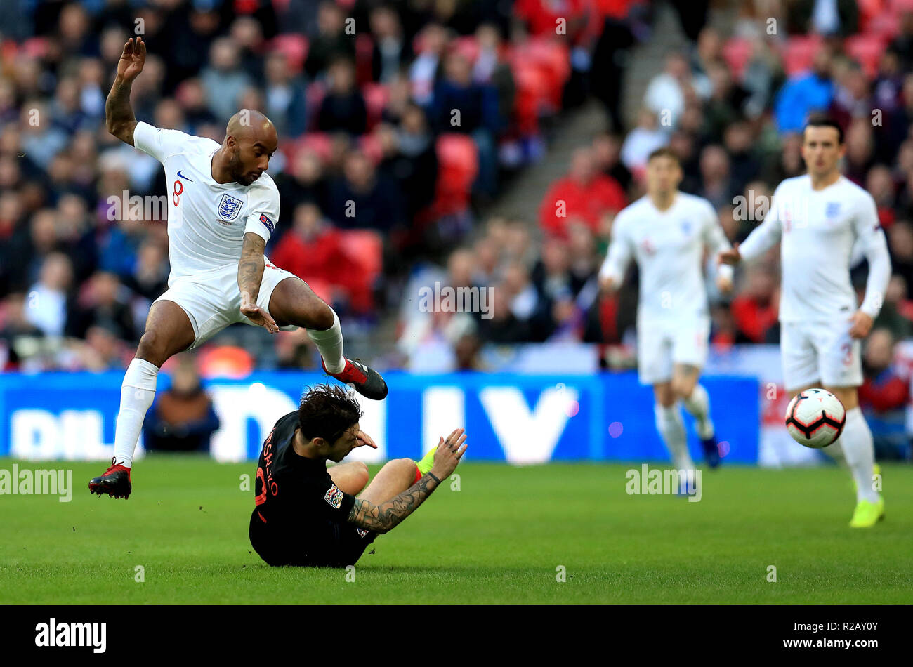 Croatia's Sime Vrsaljko (left) slides in on England's Fabian Delph (right) during the UEFA Nations League, Group A4 match at Wembley Stadium, London. Stock Photo