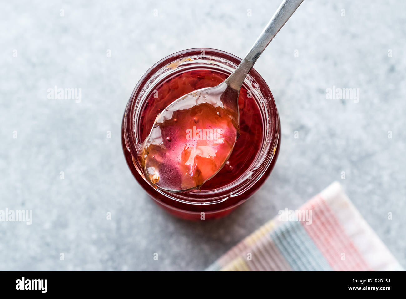 Homemade Jam of Rose Petals in Jar with Spoon / Marmalade. Organic Food