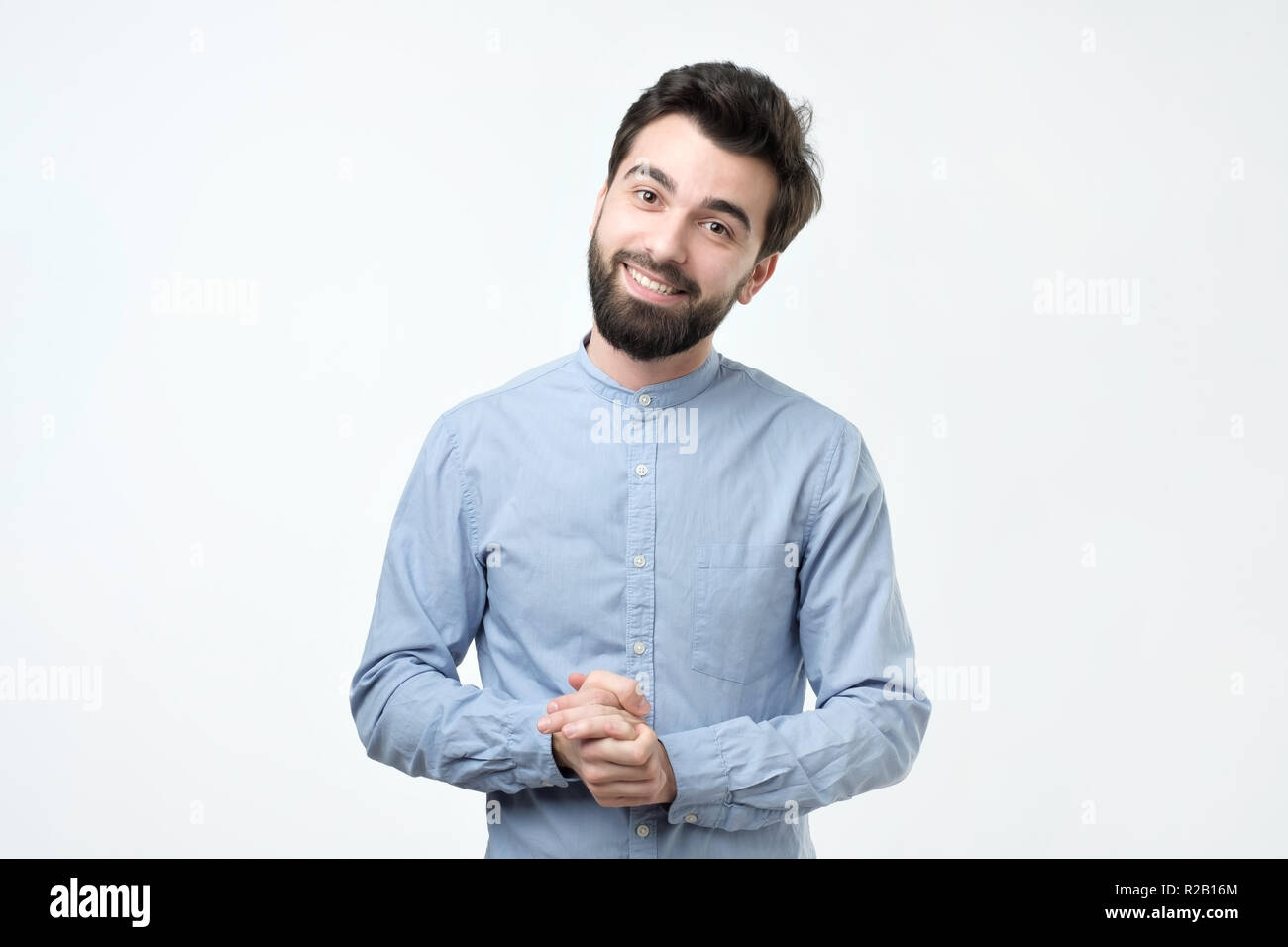 happy fashionable handsome man in blue shirt looking at camera Stock Photo