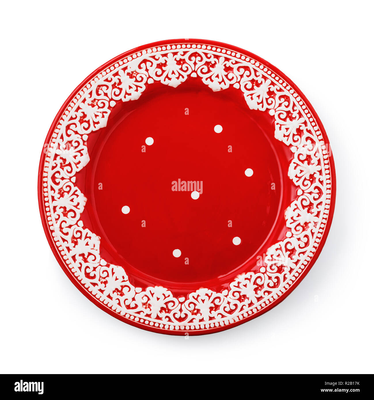 Red ceramic plate with white pattern isolated on white background Stock Photo