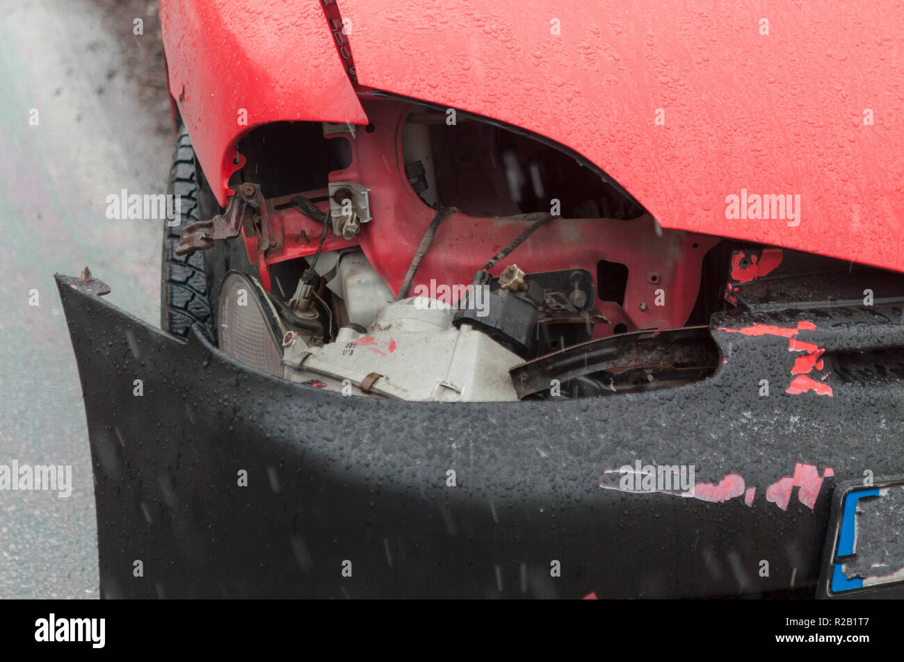 Car accident in the road. Broken car, the engine oil leaked, wheel