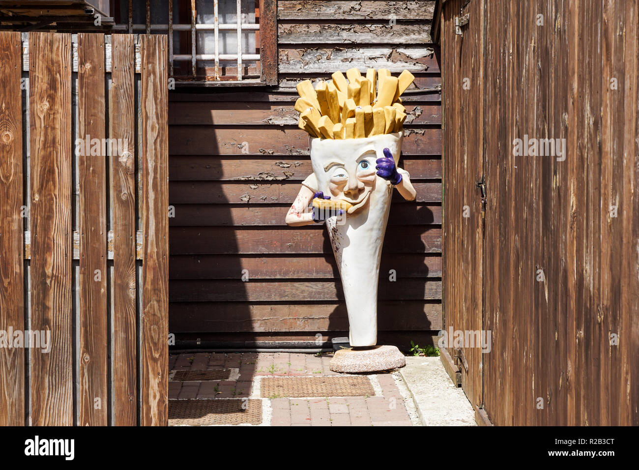 Milan , Italy 17 July 2018 : an abandoned statue that represents the advertising of a fries shop . French fries mascots are the favorite side dish and they pair on many hamburgers Stock Photo